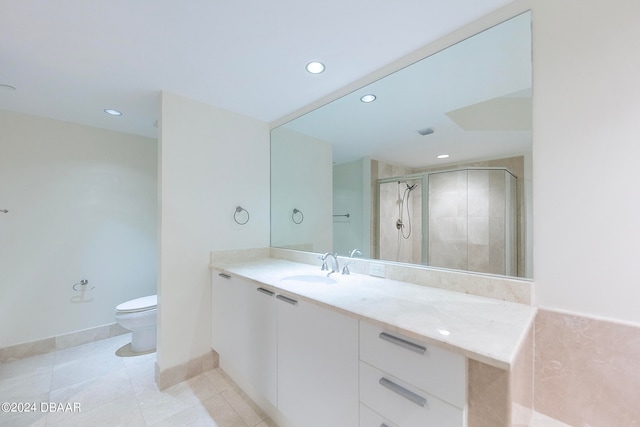 bathroom featuring vanity, a shower with shower door, tile patterned flooring, and toilet