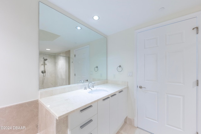 bathroom featuring vanity, tile patterned floors, and a shower with shower door