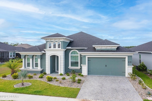 view of front of house with a front lawn and a garage