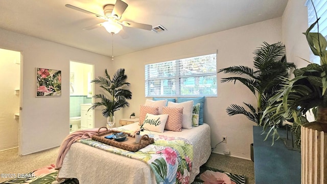 bedroom with ensuite bath and ceiling fan