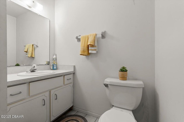 bathroom with vanity, toilet, and tile patterned flooring