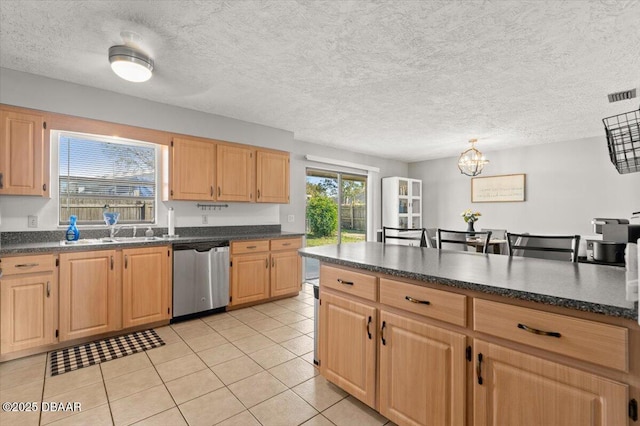 kitchen featuring stainless steel dishwasher, light brown cabinetry, and light tile patterned floors