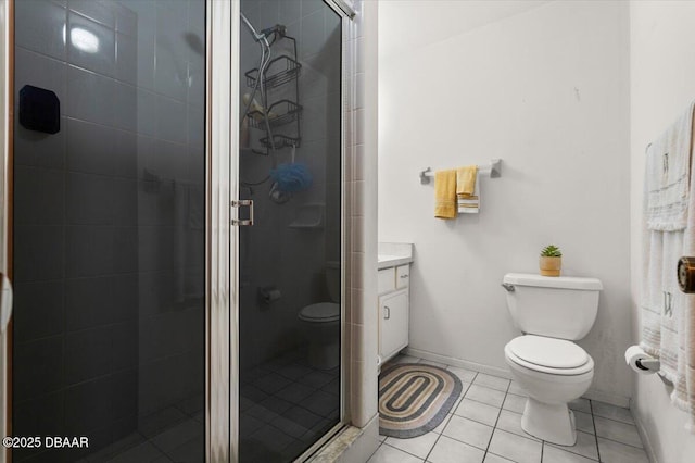 bathroom featuring a shower with door, vanity, tile patterned floors, and toilet