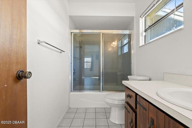 full bathroom featuring vanity, tile patterned floors, shower / bath combination with glass door, and toilet