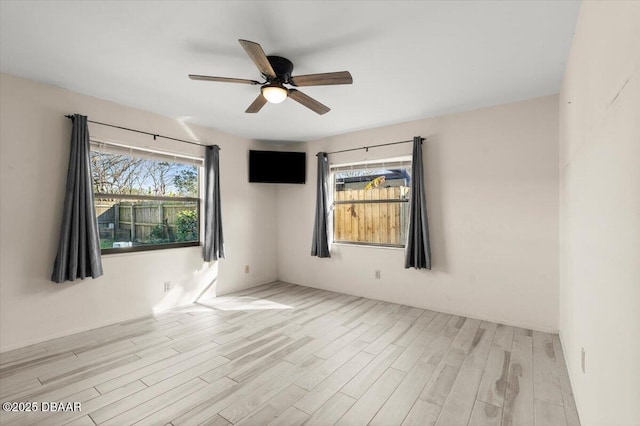 empty room featuring ceiling fan and light hardwood / wood-style floors