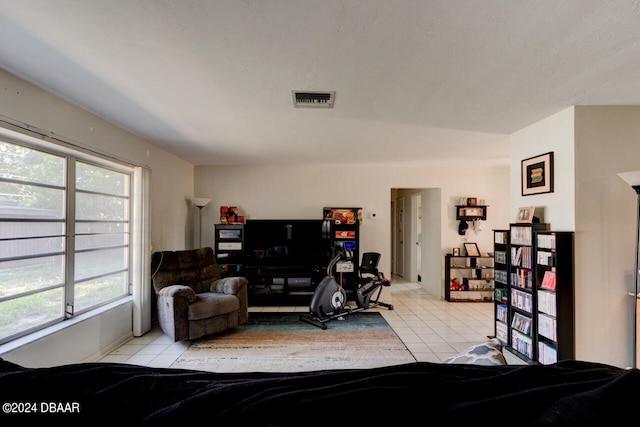 bedroom featuring multiple windows and light tile patterned flooring