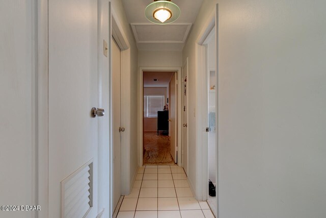 hall with light tile patterned floors