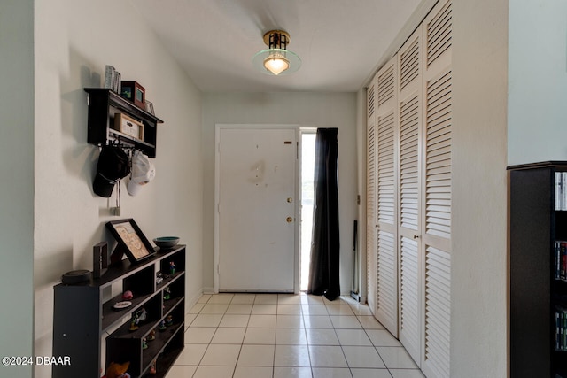 foyer entrance with light tile patterned flooring