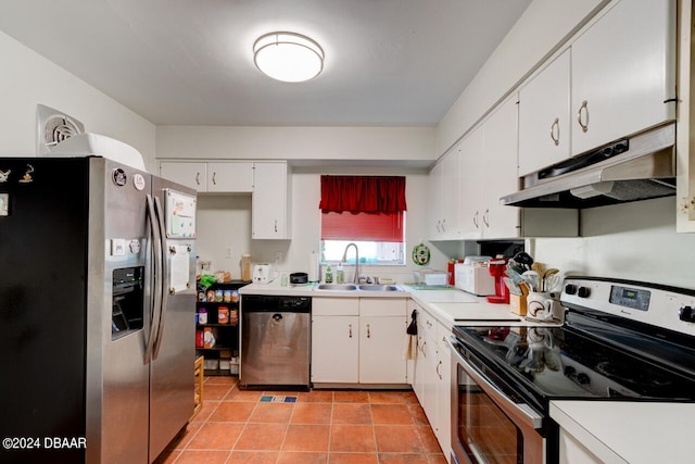 kitchen featuring stainless steel appliances, light tile patterned flooring, white cabinetry, and sink