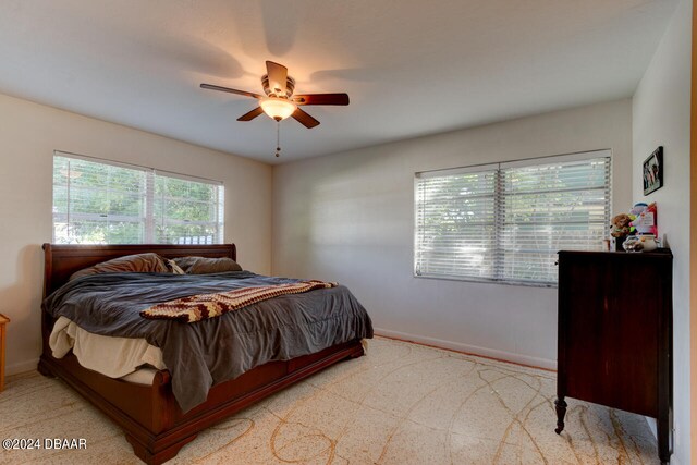 bedroom with ceiling fan and light carpet