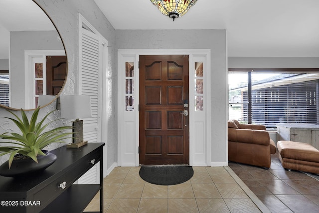 entryway with light tile patterned floors