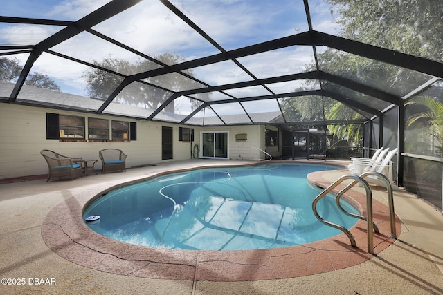 view of pool with a patio and glass enclosure