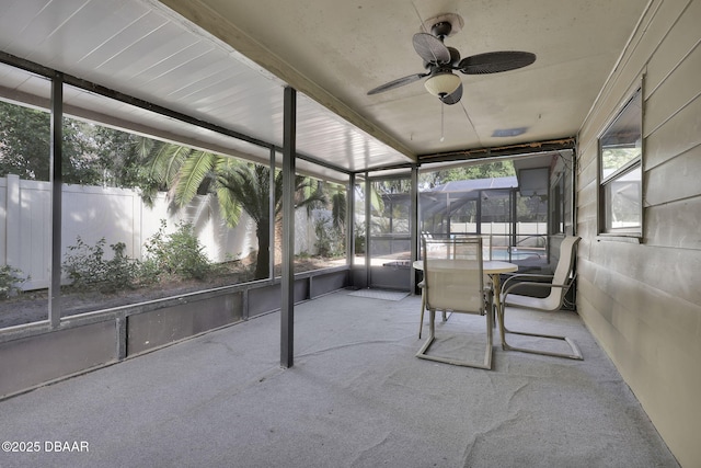 unfurnished sunroom with ceiling fan