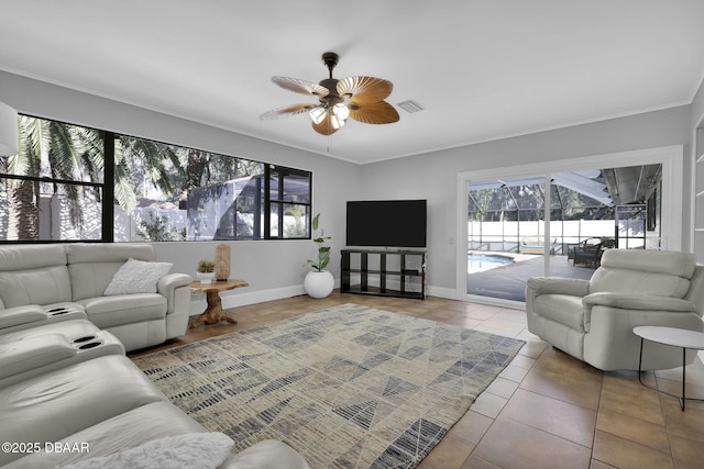 living room with ornamental molding, tile patterned floors, and ceiling fan