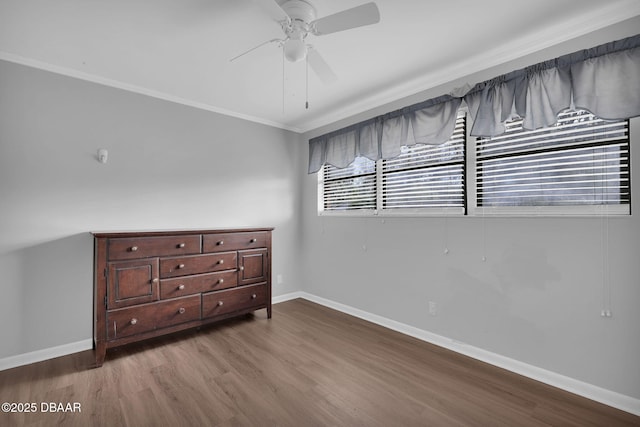 unfurnished bedroom with crown molding, ceiling fan, and wood-type flooring