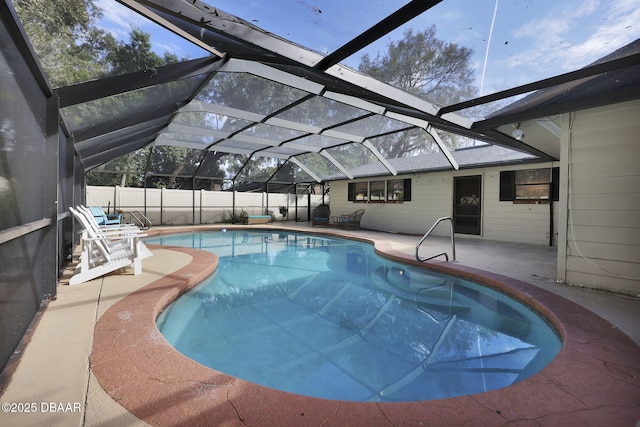 view of swimming pool featuring a patio and a lanai