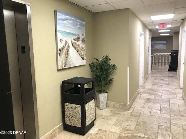 3501 S Atlantic Ave Unit 2050, Daytona Beach, FL 32118 - corridor with a paneled ceiling, elevator, and stone tile floors