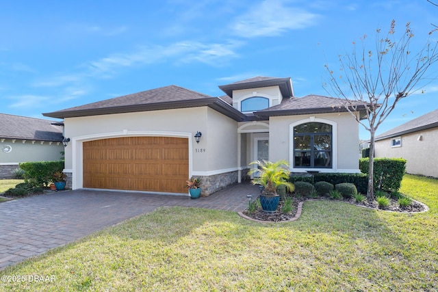 view of front of home featuring a garage and a front lawn