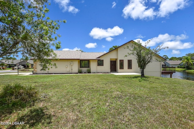 ranch-style home with a front lawn