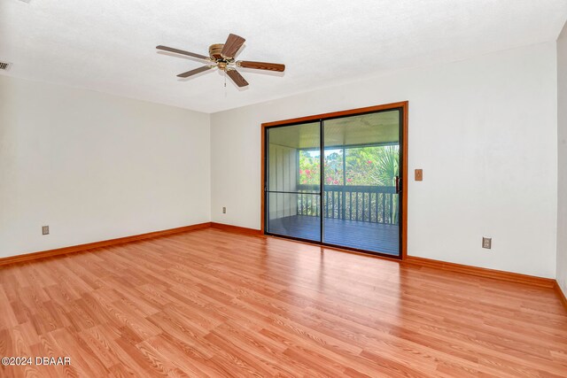 unfurnished room with ceiling fan, a textured ceiling, and light wood-type flooring