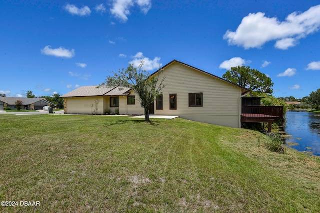 view of front facade with a front yard and a water view