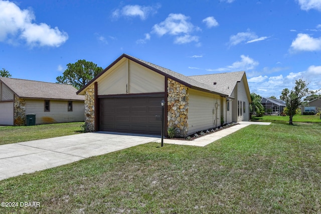 single story home featuring a garage and a front lawn