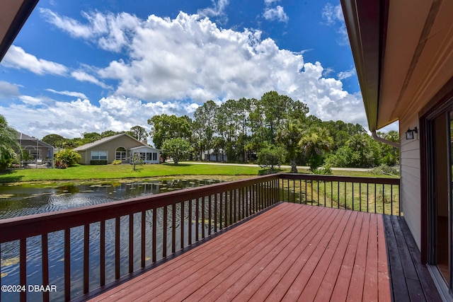 wooden deck featuring a yard and a water view