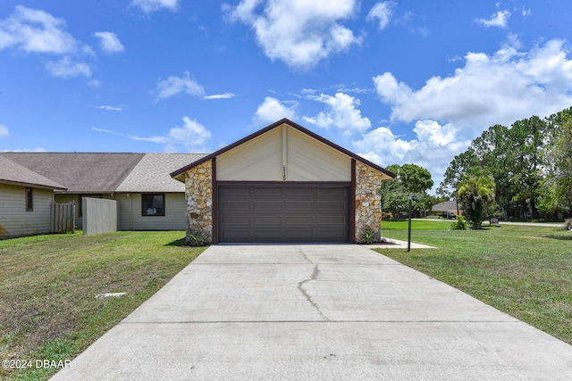 single story home with a garage and a front lawn