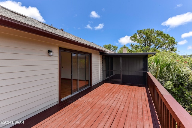 wooden deck with a sunroom