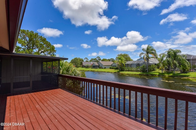 wooden terrace featuring a water view