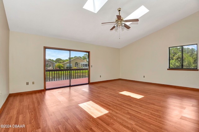 unfurnished room featuring ceiling fan, high vaulted ceiling, light hardwood / wood-style flooring, and a skylight