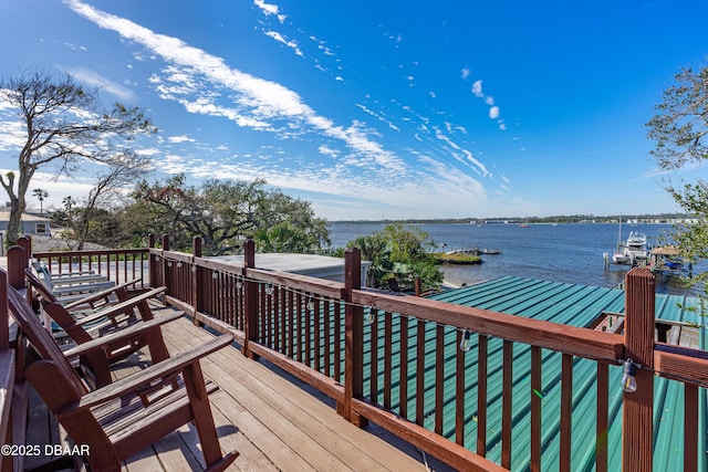 wooden deck featuring a dock and a water view