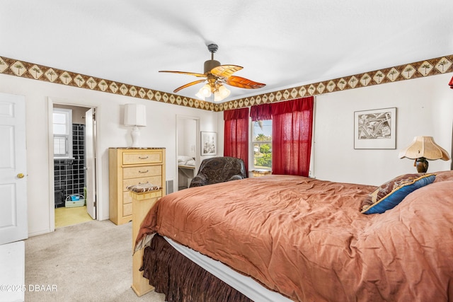 bedroom featuring connected bathroom, a ceiling fan, and light carpet