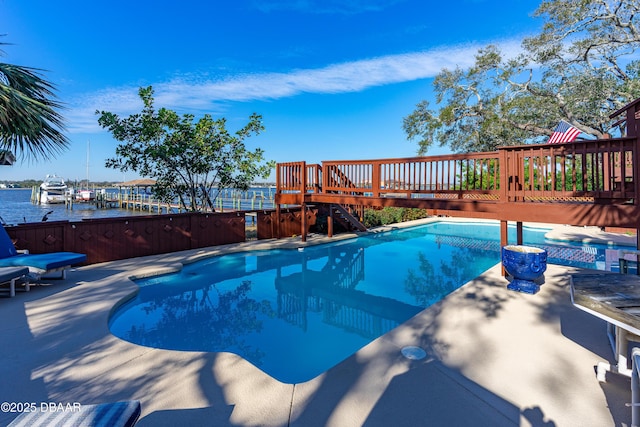 view of swimming pool with a fenced in pool and a deck