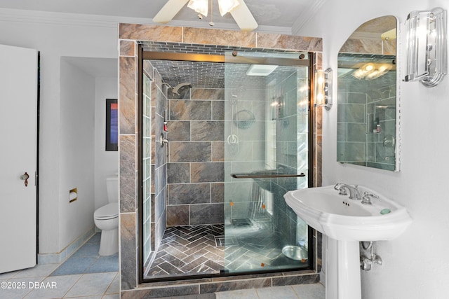 bathroom with tile patterned floors, a shower with shower door, ornamental molding, and toilet