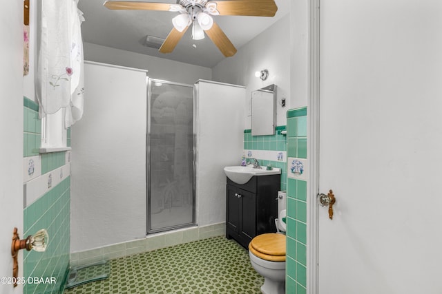 full bathroom with toilet, a stall shower, vanity, and ceiling fan