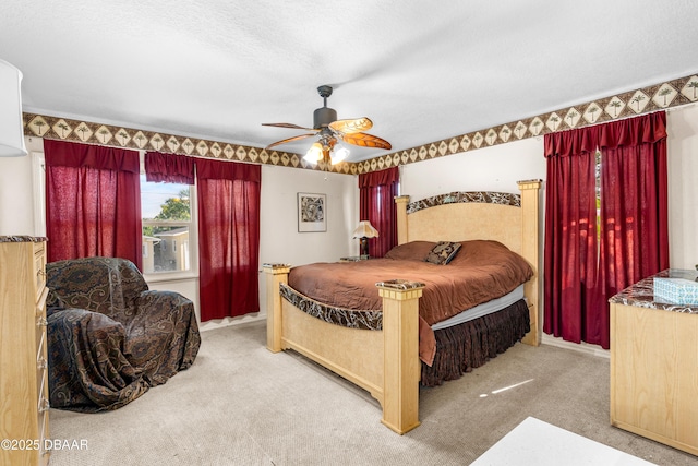 carpeted bedroom featuring a textured ceiling and ceiling fan