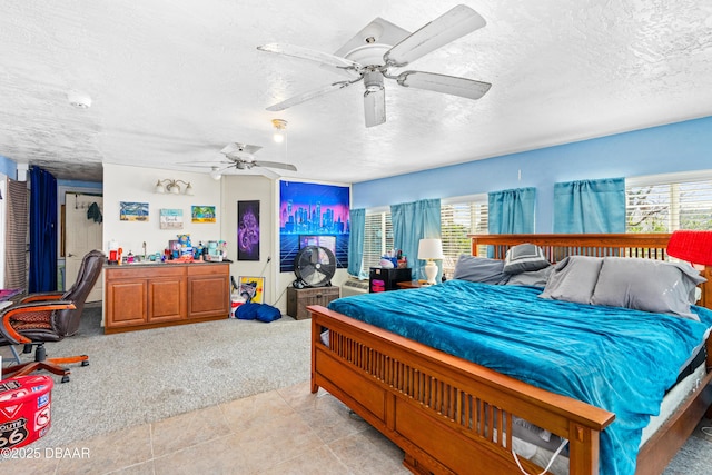 carpeted bedroom with multiple windows, ceiling fan, and a textured ceiling