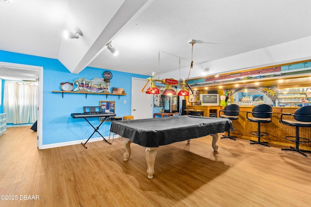 rec room with a bar, billiards, baseboards, and wood finished floors