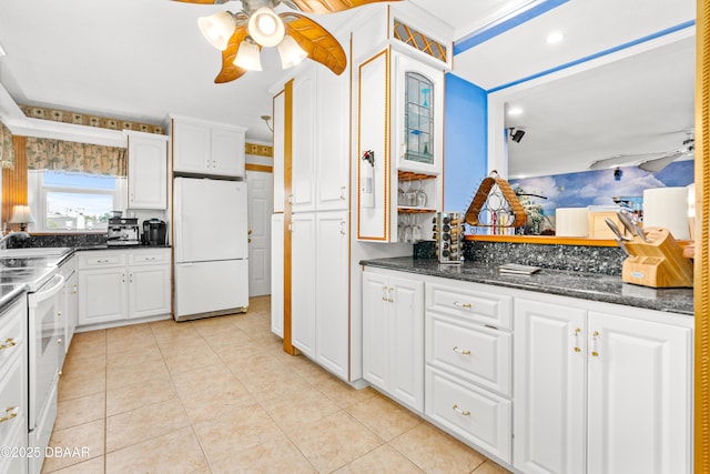 kitchen with white appliances, a ceiling fan, and white cabinetry