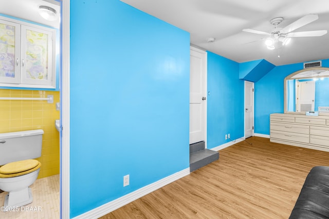 additional living space featuring ceiling fan and light wood-type flooring