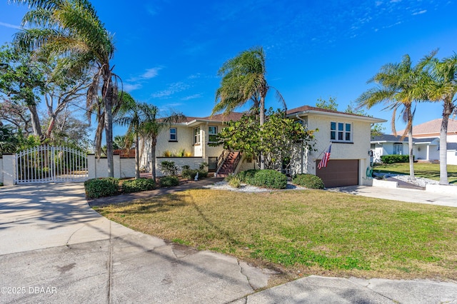 view of front of home with a garage and a front lawn