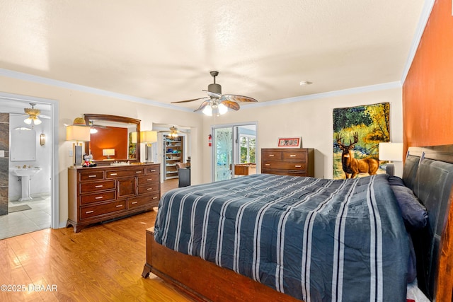 bedroom with ceiling fan, connected bathroom, light wood finished floors, and ornamental molding