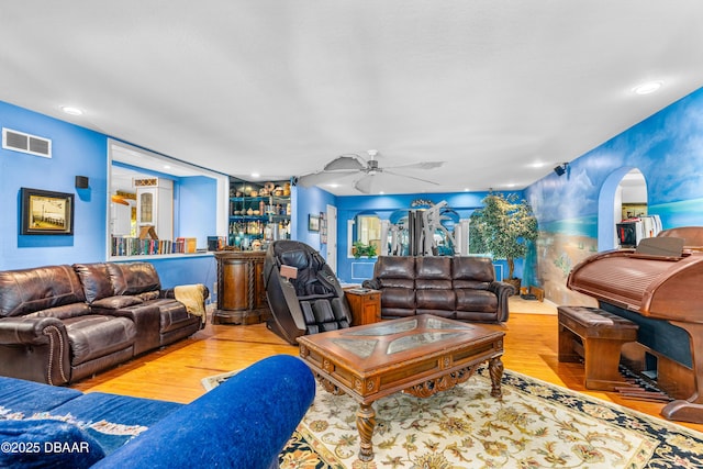 living room featuring light hardwood / wood-style flooring and ceiling fan