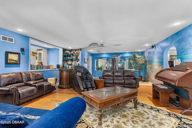 living room with a ceiling fan, recessed lighting, wood finished floors, and visible vents