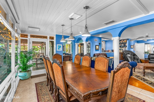 dining space with light tile patterned floors, wooden ceiling, ceiling fan, and ornate columns