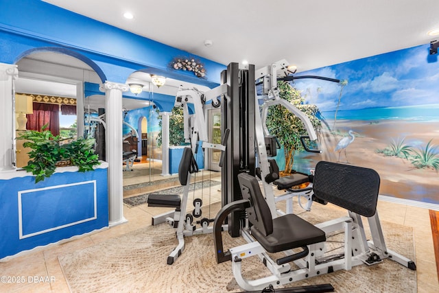 workout room featuring tile patterned flooring and ornate columns