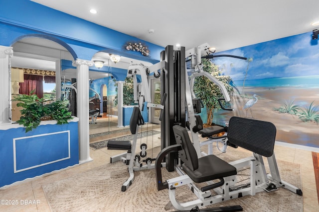 workout area with tile patterned flooring, decorative columns, recessed lighting, and arched walkways