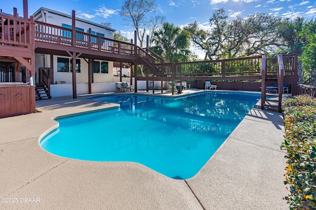 view of swimming pool with a deck and a patio