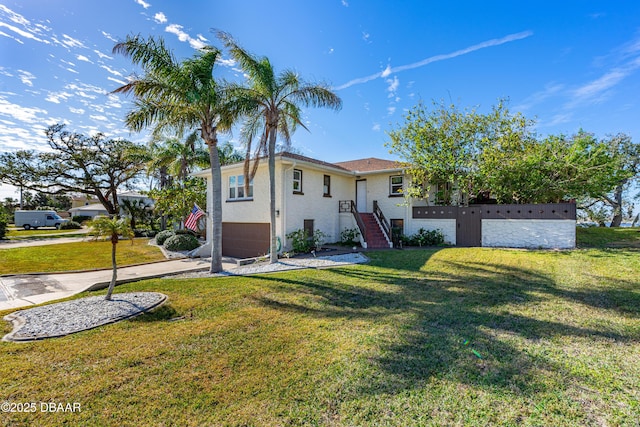 split foyer home with a front lawn, concrete driveway, and a garage